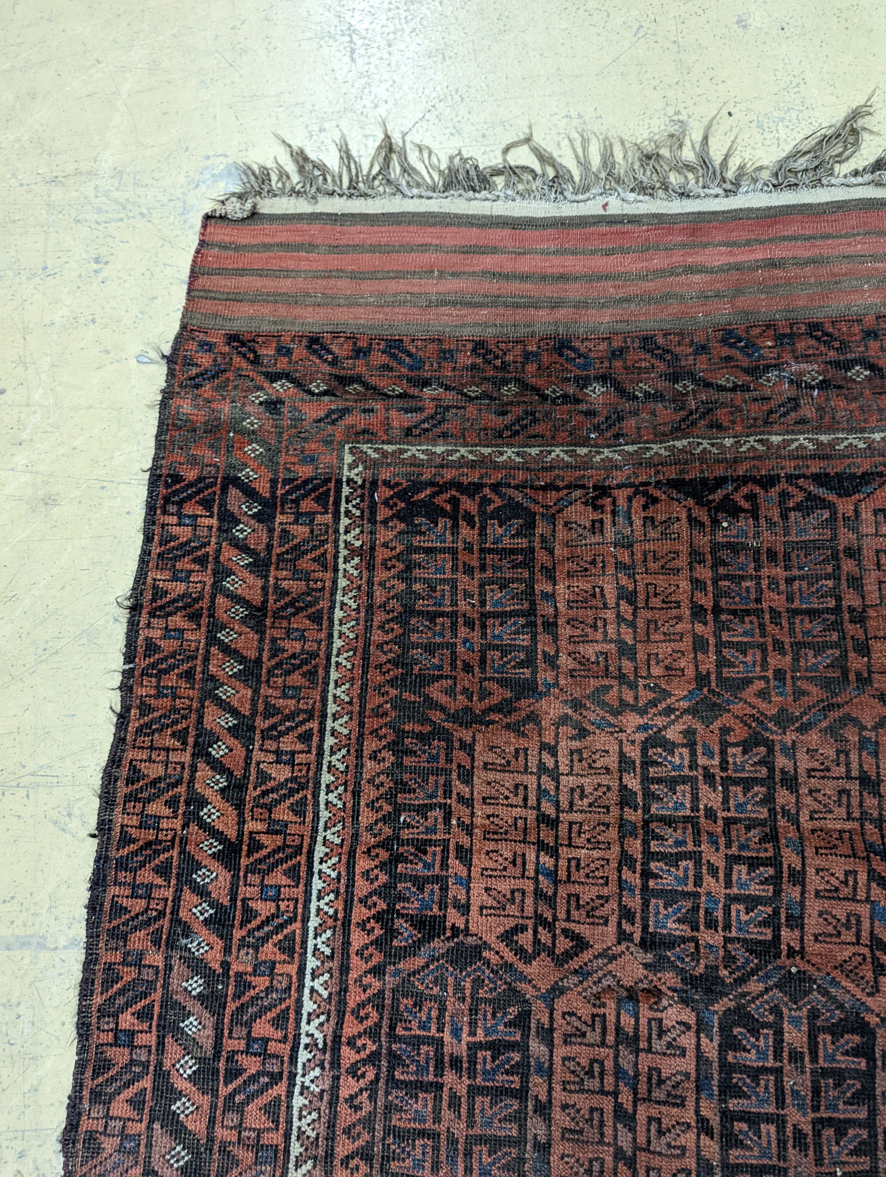 A Belouch red ground rug and a prayer rug, largest 178 x 106cm